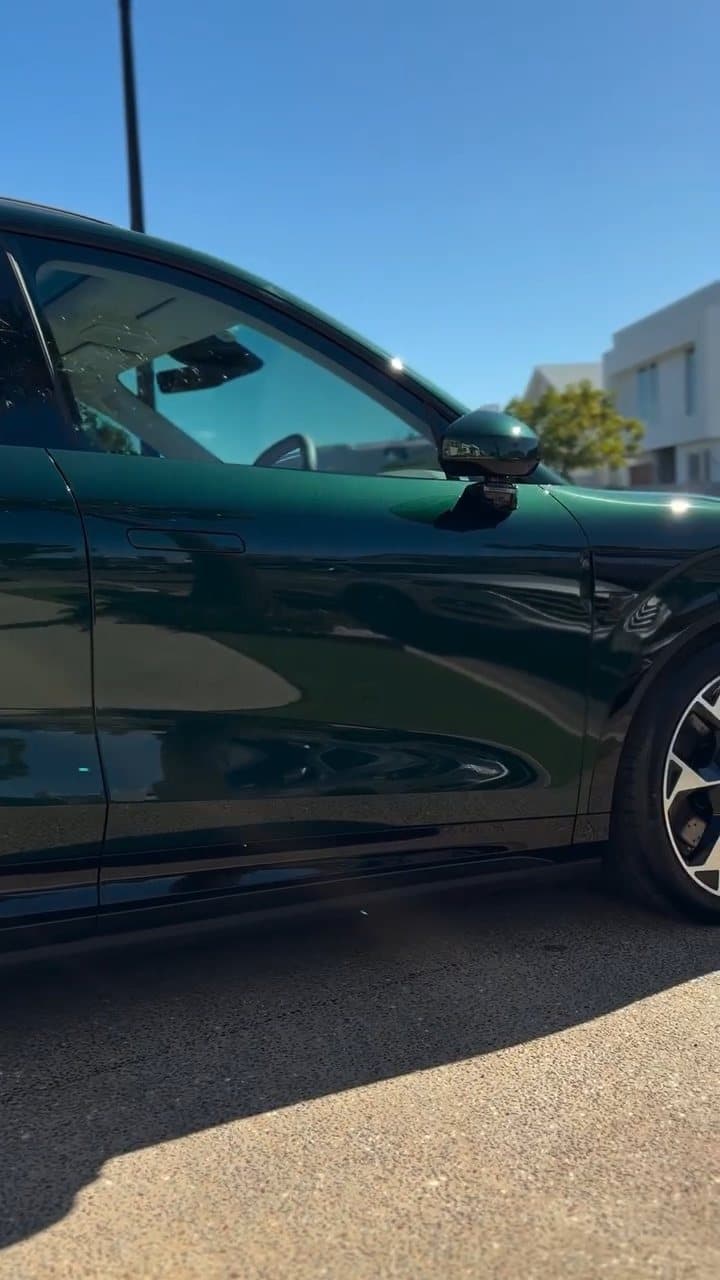 Reflections along the side of a dark green SUV after ceramic coating