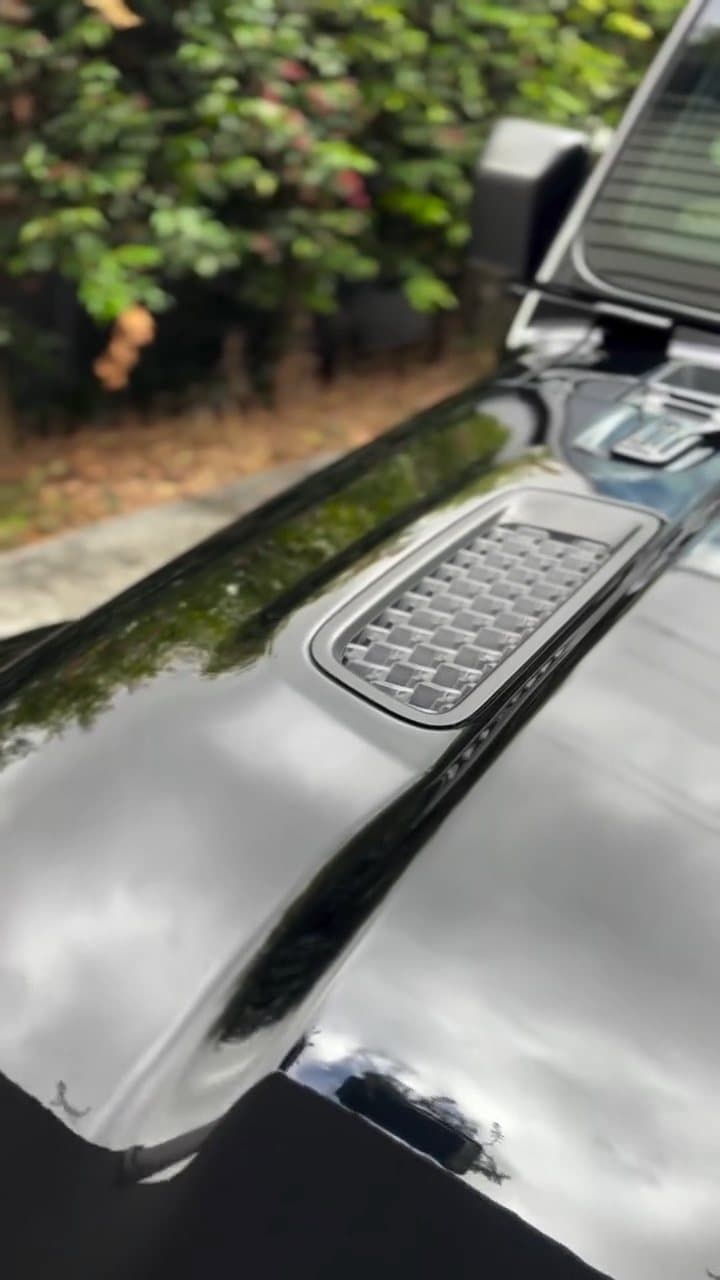 Deep gloss on the bonnet vent of a black Jeep Wrangler