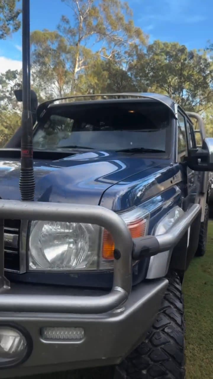 Front of a blue Toyota LandCruiser 79 with bullbar and light bar